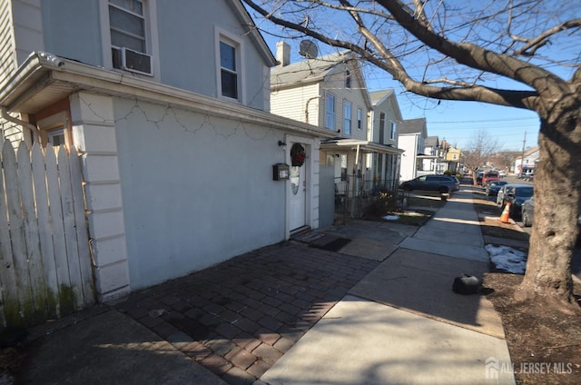 view of side of home with stucco siding and a residential view