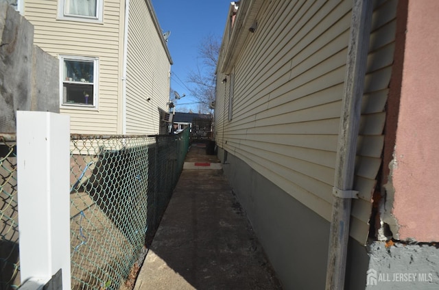 view of side of property featuring fence