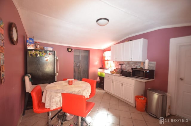 132 Hale St, New Brunswick, NJ 08901 - dining space with lofted ceiling, ornamental molding, and light tile patterned floors