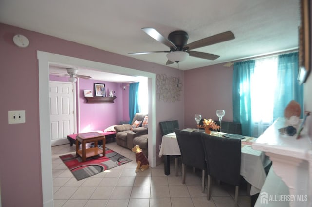 dining area with a ceiling fan and light tile patterned flooring