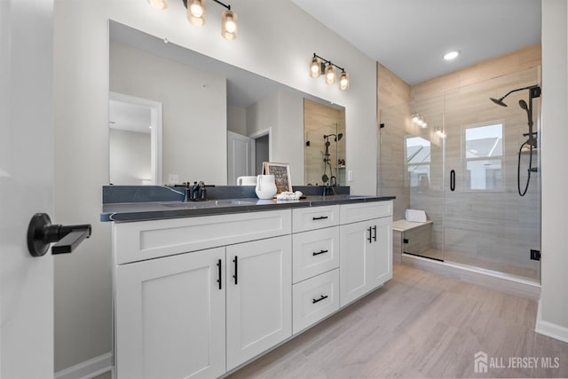 1306 Parker Blvd, West Windsor, NJ 08550 - bathroom featuring double vanity, a stall shower, and wood finished floors