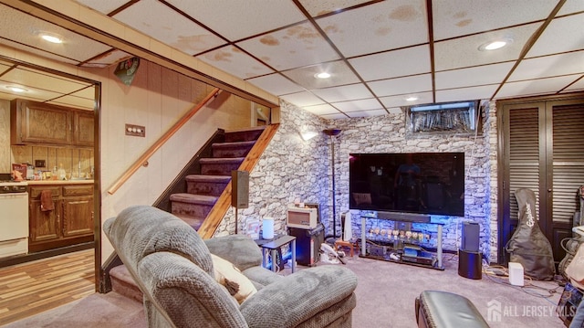 living room with a paneled ceiling and light hardwood / wood-style floors