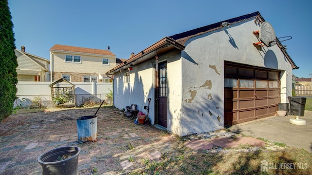 view of home's exterior with a garage and an outdoor structure