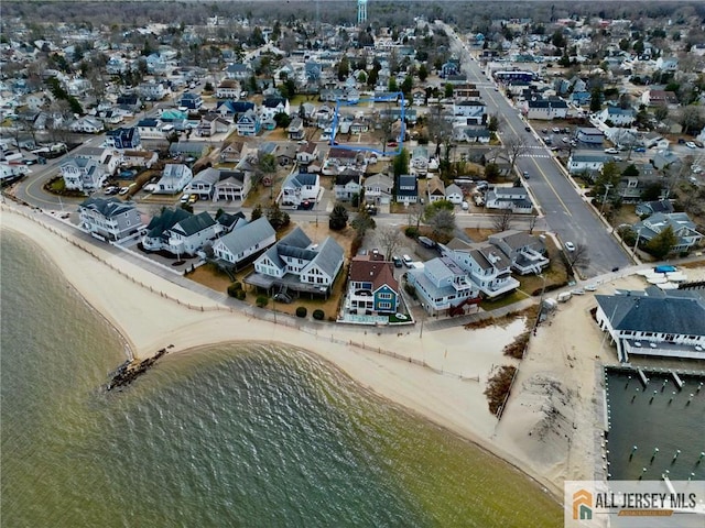 birds eye view of property with a water view and a view of the beach