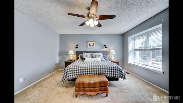 carpeted bedroom with baseboards, a textured ceiling, and ceiling fan