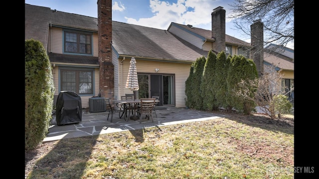 rear view of house featuring a patio and central AC