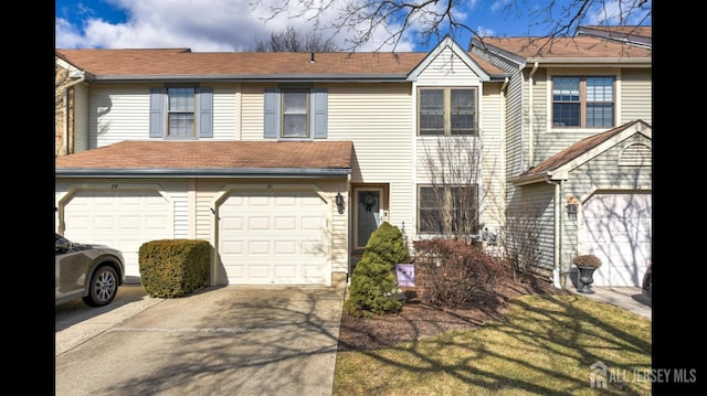 view of property with driveway and a garage