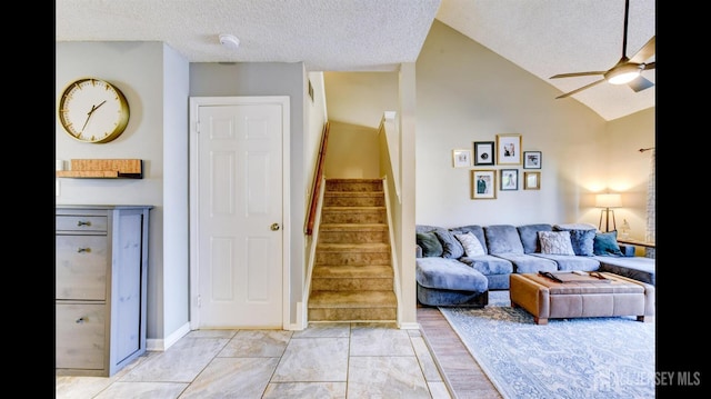 living area featuring visible vents, stairway, vaulted ceiling, a textured ceiling, and a ceiling fan