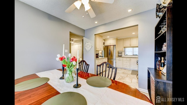 dining space with recessed lighting, a textured ceiling, and a ceiling fan