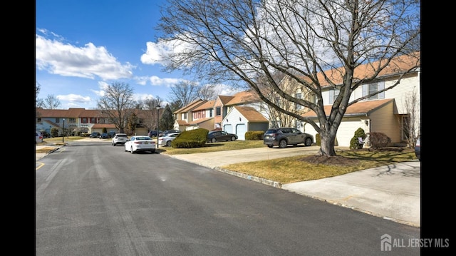 view of road with a residential view and curbs