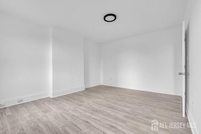 unfurnished room with light hardwood / wood-style flooring