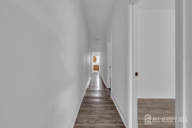 hallway featuring dark wood-type flooring