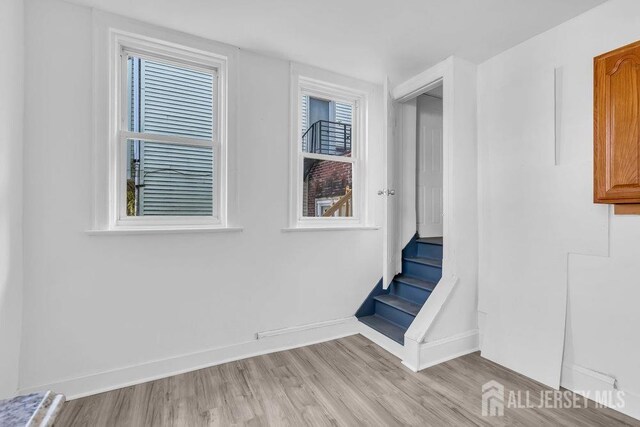 stairway featuring hardwood / wood-style flooring and plenty of natural light