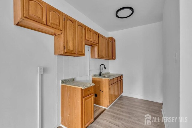 kitchen featuring sink and light wood-type flooring