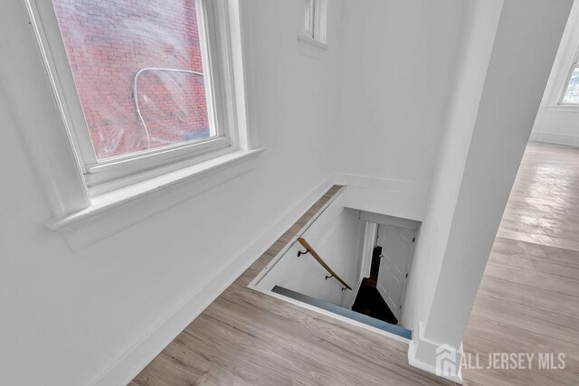 stairs featuring hardwood / wood-style flooring