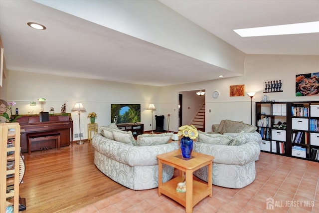 25 Deer Path, Holmdel, NJ 07733 - living area featuring stairway, vaulted ceiling, a skylight, and light wood-type flooring