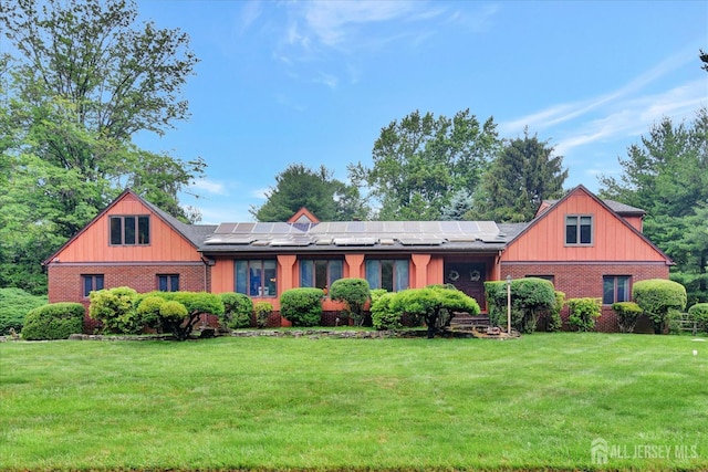 25 Deer Path, Holmdel, NJ 07733 - view of front of property with brick siding, a front yard, and solar panels