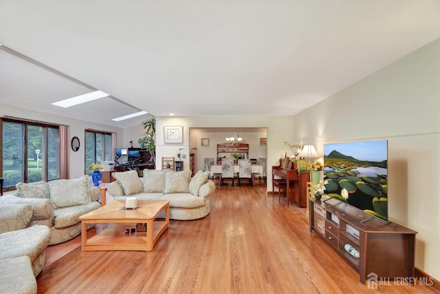 25 Deer Path, Holmdel, NJ 07733 - living area featuring a chandelier, a skylight, and light wood-type flooring
