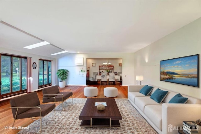 25 Deer Path, Holmdel, NJ 07733 - living area with a chandelier, wood finished floors, and lofted ceiling