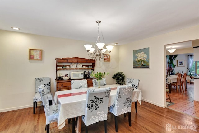 25 Deer Path, Holmdel, NJ 07733 - dining area with a chandelier and light wood-style flooring