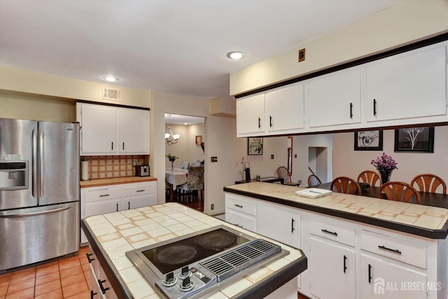 25 Deer Path, Holmdel, NJ 07733 - kitchen with stainless steel fridge, tile counters, stovetop with downdraft, white cabinets, and recessed lighting