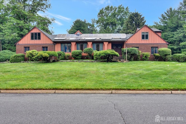 25 Deer Path, Holmdel, NJ 07733 - view of front of property with brick siding, a front yard, and solar panels