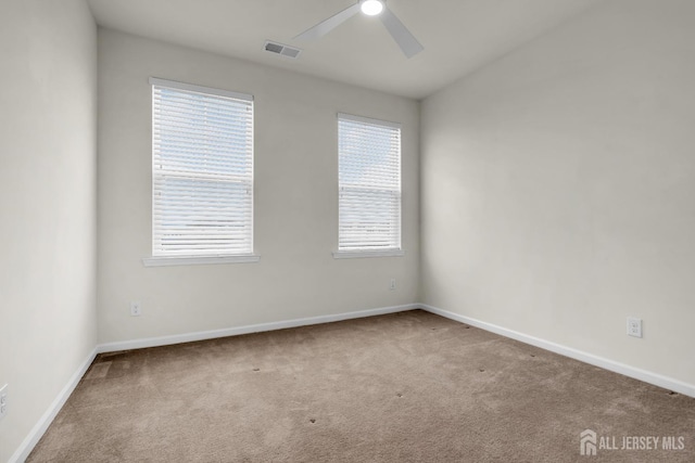 empty room with ceiling fan and carpet