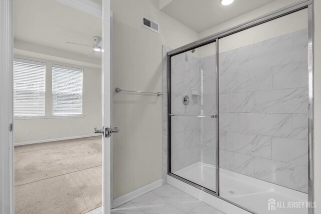 bathroom with ceiling fan and walk in shower