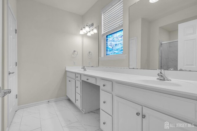 bathroom featuring an enclosed shower and vanity