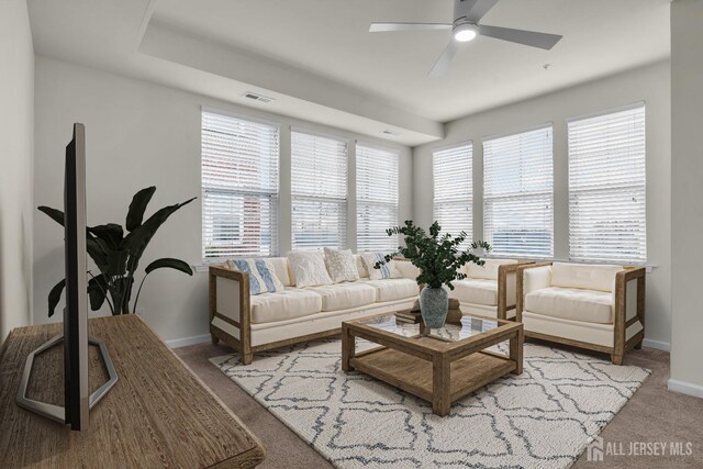 carpeted living room featuring ceiling fan