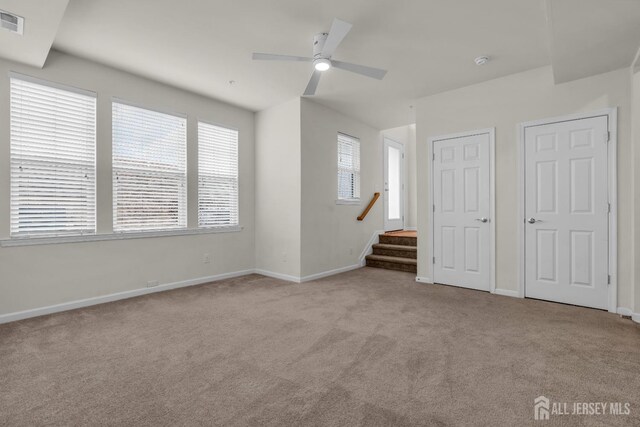 interior space with ceiling fan