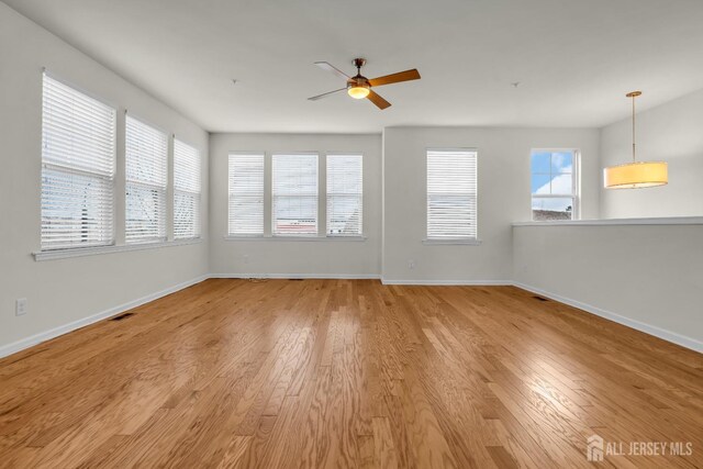 unfurnished room featuring ceiling fan and light wood-type flooring