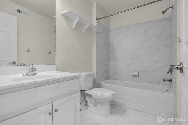 full bathroom featuring vanity, toilet, and tiled shower / bath combo