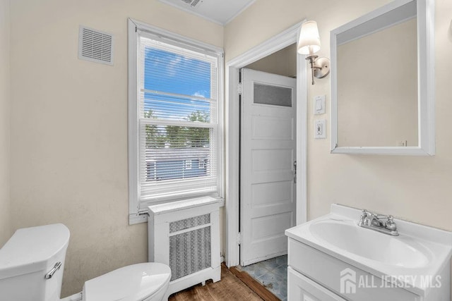 12 Dey St, Englishtown, NJ 07726 - half bath with vanity, radiator heating unit, and wood finished floors