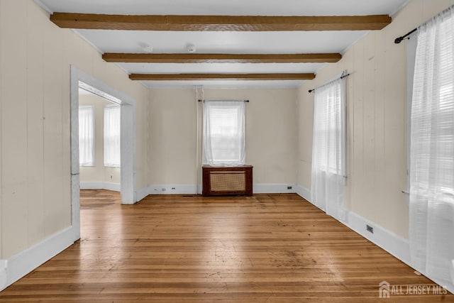 12 Dey St, Englishtown, NJ 07726 - empty room with light wood-type flooring, healthy amount of natural light, beamed ceiling, and wooden walls