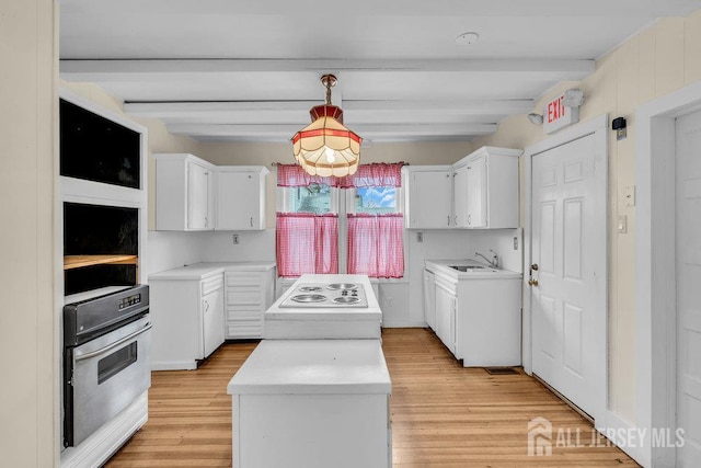 12 Dey St, Englishtown, NJ 07726 - kitchen with stainless steel oven, a center island, beam ceiling, white electric cooktop, and light wood-style flooring