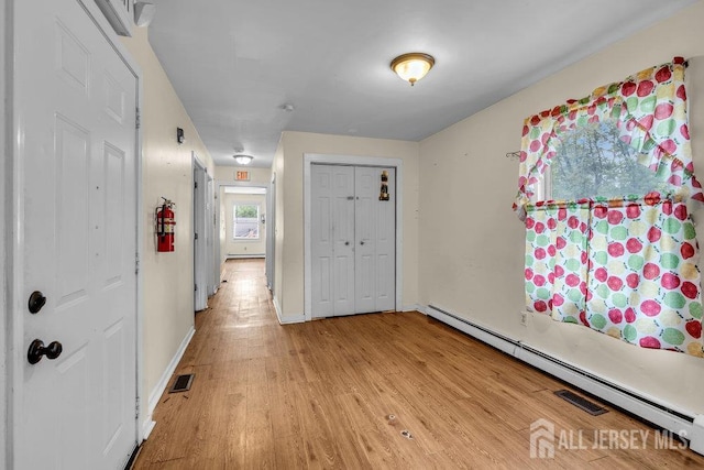 12 Dey St, Englishtown, NJ 07726 - entrance foyer featuring baseboard heating, light wood-type flooring, and a baseboard radiator