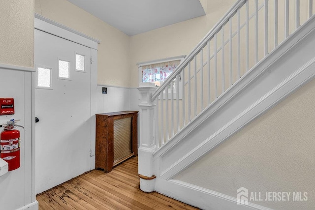 12 Dey St, Englishtown, NJ 07726 - foyer entrance with wood-type flooring, stairway, and a wainscoted wall