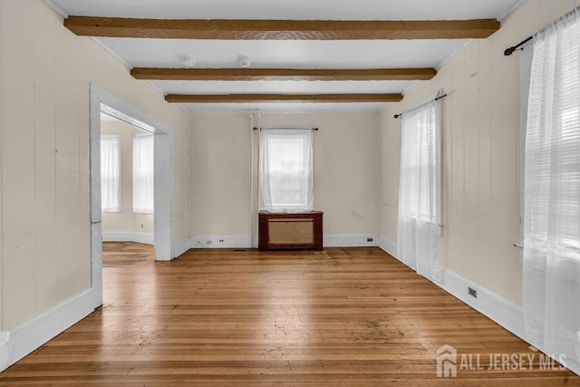 12 Dey St, Englishtown, NJ 07726 - spare room featuring healthy amount of natural light, wood-type flooring, beam ceiling, and wood walls