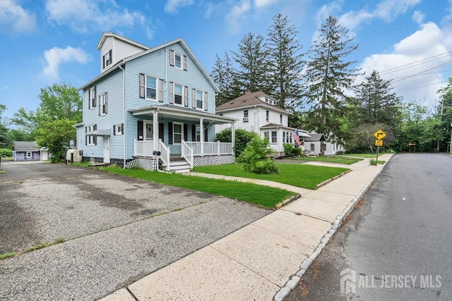 12 Dey St, Englishtown, NJ 07726 - view of front of home with covered porch and a front yard