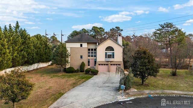 view of front of house with a garage and a front yard