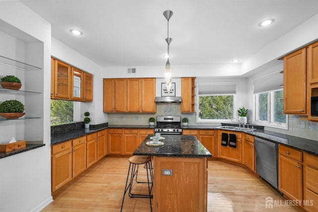 kitchen with dishwashing machine, visible vents, open shelves, and stainless steel range with gas stovetop