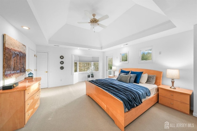 bedroom with recessed lighting, ceiling fan, a raised ceiling, and light colored carpet