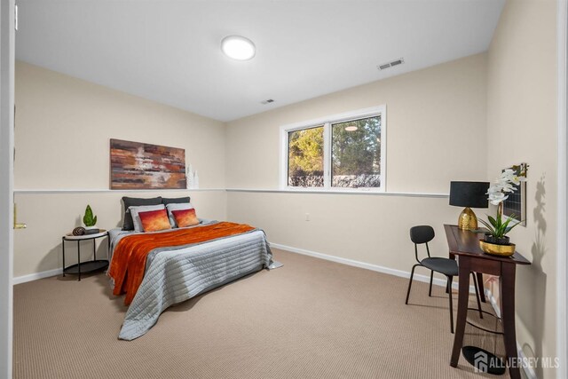 bedroom featuring visible vents, carpet, and baseboards