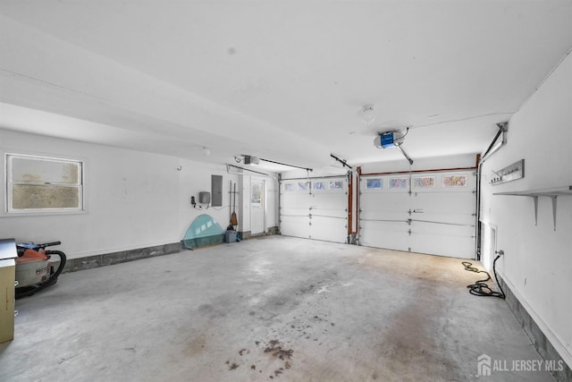 garage featuring a garage door opener, electric panel, and baseboards