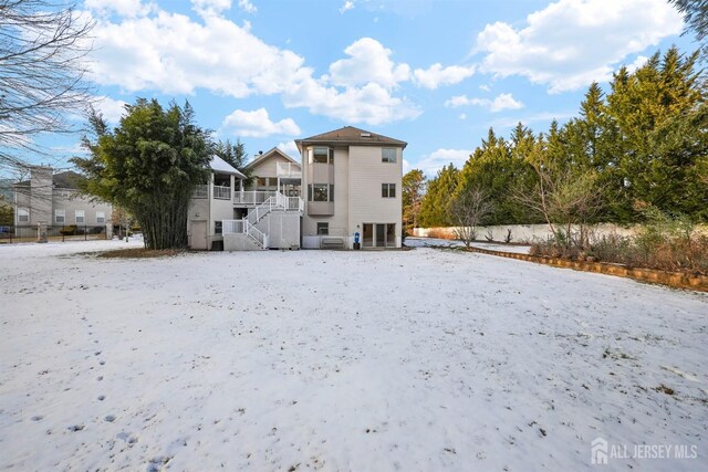 rear view of property with stairs