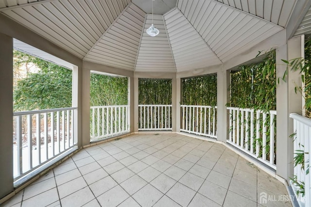 unfurnished sunroom featuring vaulted ceiling