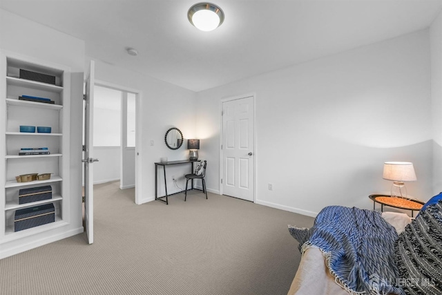 carpeted bedroom featuring baseboards