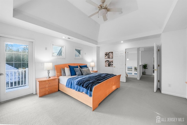 carpeted bedroom featuring visible vents, baseboards, a raised ceiling, a ceiling fan, and access to exterior