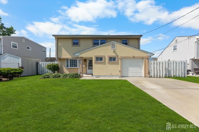 53 Tennyson St, Carteret, NJ 07008 - view of front of property with stucco siding, driveway, and an attached garage